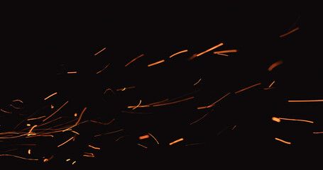 hot sparks floating from side on black background