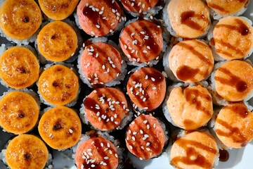 Japanese sushi in a row with a textured background