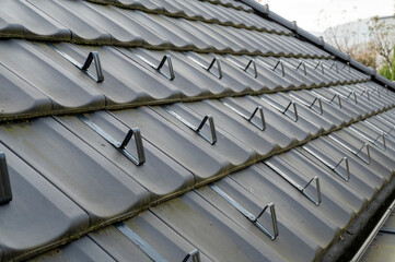 Snow guards, retainers  or snow hooks on the tile roof. Snow guards to keep snow from sliding off the roof too quickly.