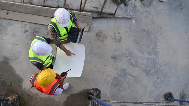 A Group of Construction Engineers Discussing the Project Plan at the Building Site,Collaborating with Architects on Structural Design and Civil Engineers Brainstorming Construction Strategies