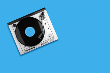 Vinyl Record player, blue background. Top view. Copy space. Musical