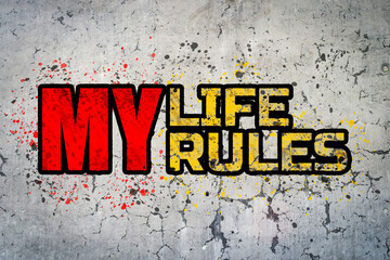 My life my rules. Motivational sticker on a cracked concrete wall background.
