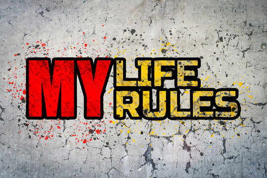 My life my rules. Motivational sticker on a cracked concrete wall background.