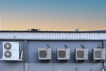 Air conditioner compressor installed in old building. Outdoor split wall type air conditioner...