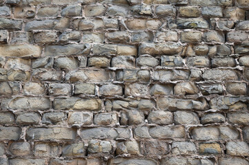 The photo shows a wall made of old bricks close-up