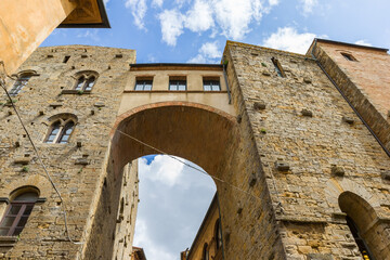 Bridge between two historic buildings in Volterra, Italy
