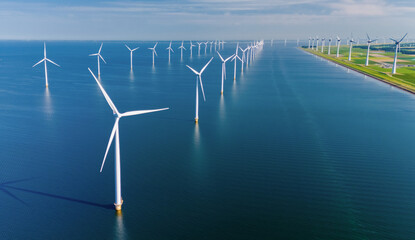 Windmill turbines at sea seen from a drone aerial view from abov