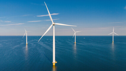 Windmill turbines at sea seen from a drone aerial view from abov