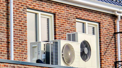 air source heat pump unit installed outdoors at a modern home with solar panels in the Netherlands