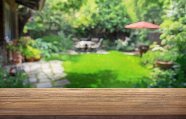 summer time party in backyard garden with grill BBQ, wooden table, blurred background