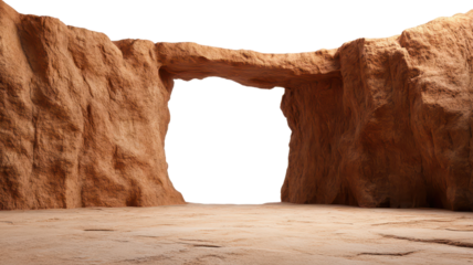 A natural rock formation featuring a prominent archway, set against a dark backdrop, showcasing earthy textures and a sandy floor.
