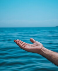 Open hand reaching out towards a vast tranquil ocean under a clear blue sky : Generative AI