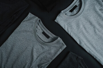 Two shirts are laid out on a black background