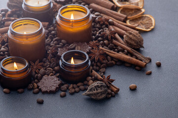 Soy scented candle in a jar. Coffee aroma background. Candles light burning fire