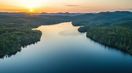 Fototapeta premium Serene aerial view of a sweeping forested landscape and lake at sunrise : Generative AI