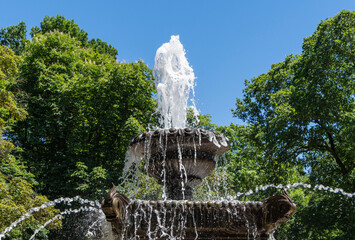 Frogs Fountain is located on central alley in central park. Two bowls of fountain are filled with water. Streams of water flow in different directions. Stavropol, Russia - May 23, 2024