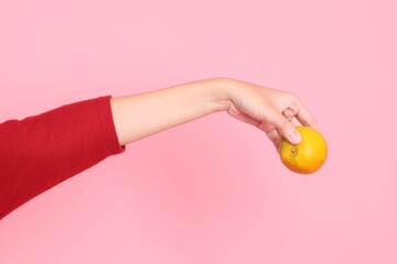 hand holding Tangerine or Orange