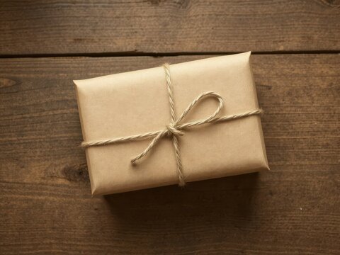 Rustic brown paper parcel secured with twine, simple knot, shipping,home,supplies