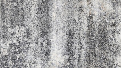 Old gray cement wall texture with black stains, Textured color on cement background. Old concrete wall with cracked flaking paint. The white painted wall surface has scratches and peeling paint.