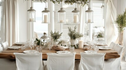 A coastal dining room with a driftwood table, white slipcovered chairs, and glass lanterns hanging from the ceiling