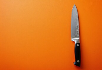 Sharp Kitchen Knife on Orange Background Minimalist Food Photography