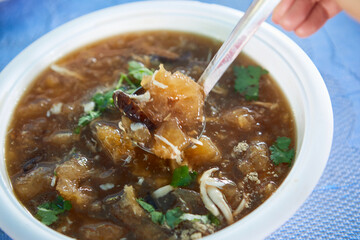 People eating Braised fish maw with chicken meat  in bowl