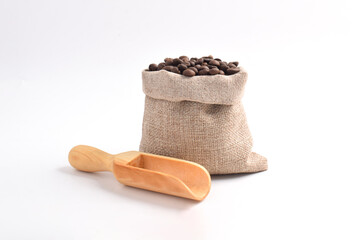 Sack with brown roasted coffee beans. Burlap sack. Scoop for coffee beans.