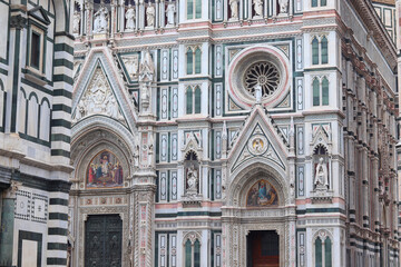 Florence, Italy - November 28, 2024: Close-up of architectural details on Florence Duomo (Cathedral of Santa Maria del Fiore), showcasing intricate Gothic design and Renaissance craftsmanship.