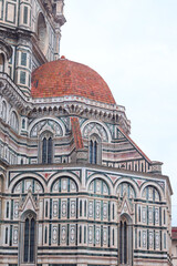 Florence, Italy - November 28, 2024: Close-up of architectural details on Florence Duomo (Cathedral of Santa Maria del Fiore), showcasing intricate Gothic design and Renaissance craftsmanship.