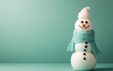 A snowman built from milk bottles stacked vertically with painted eyes and a scarf tied around the neck on a pastel green background