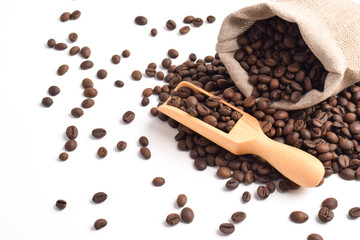 Sack with brown roasted coffee beans isolated on white background. Burlap sack. Scoop with grains.
