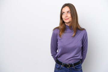 Young caucasian woman isolated on white background having doubts while looking up
