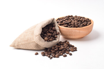 Roasted coffee beans in sack and in wooden bowl isolated on white background.