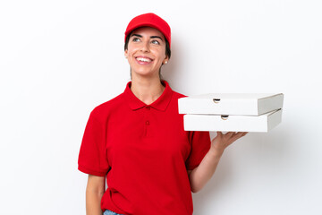 Pizza delivery caucasian woman with work uniform picking up pizza boxes isolated on white...