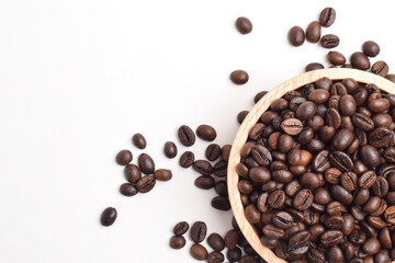 Roasted coffee bean in wooden bowl isolated on white background. Top view. Flat lay. Space for text