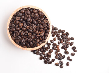 Flat lay of coffee beans in wooden bowl isolated on white background.