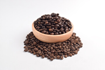 Roasted coffee bean in wooden bowl isolated on white background.