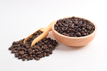 Coffee beans in wooden bowl isolated on white background