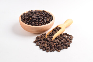 Coffee beans in wooden bowl isolated on white background