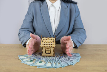 house covered of woman hands - insurance real estate concept