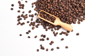 Roasted coffee beans in wooden spoon isolated on white background. Top view