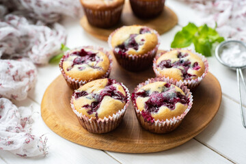 Muffins with cherries for dessert. Cherry muffins for breakfast on a white background. Close-up