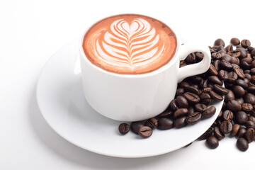 Coffee Mug with Latte Art and Coffee Beans Isolated on White Background.