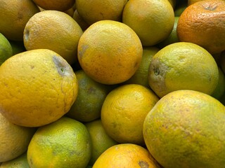 Close-up of oranges. Oranges wallpaper. Pile of oranges. Oranges as the background.