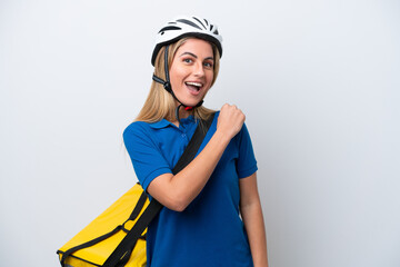Young caucasian woman with thermal backpack isolated on white background celebrating a victory
