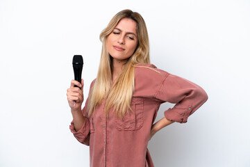 Singer Uruguayan woman picking up a microphone isolated on white background suffering from backache for having made an effort