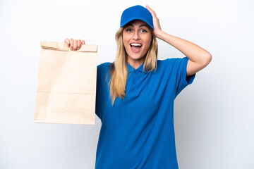 Young Uruguayan woman taking a bag of takeaway food isolated on white background with surprise expression