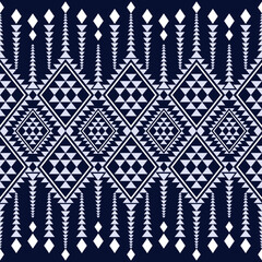 Geometric pattern featuring diamonds and triangles in navy blue and white. This design showcases modern tribal aesthetic, perfect for textiles or wallpapers