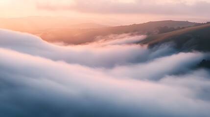 Fototapeta premium The misty mountains are covered with trees and the sky is a beautiful orange color. The misty atmosphere makes the atmosphere look peaceful, quiet and beautiful.