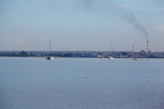 Sailboats and the chimney of Refineria Camilo at bahia de cienfuegos, Cuba